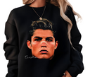 Black sweatshirt with a graphic of a face and 'Cristiano' text, worn by a person.