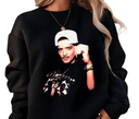 Woman styling black Velvet Showman sweatshirt, casual unisex music shirt.