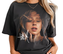 Woman styling black Tate McRae Greedy t-shirt, casual unisex pop shirt.